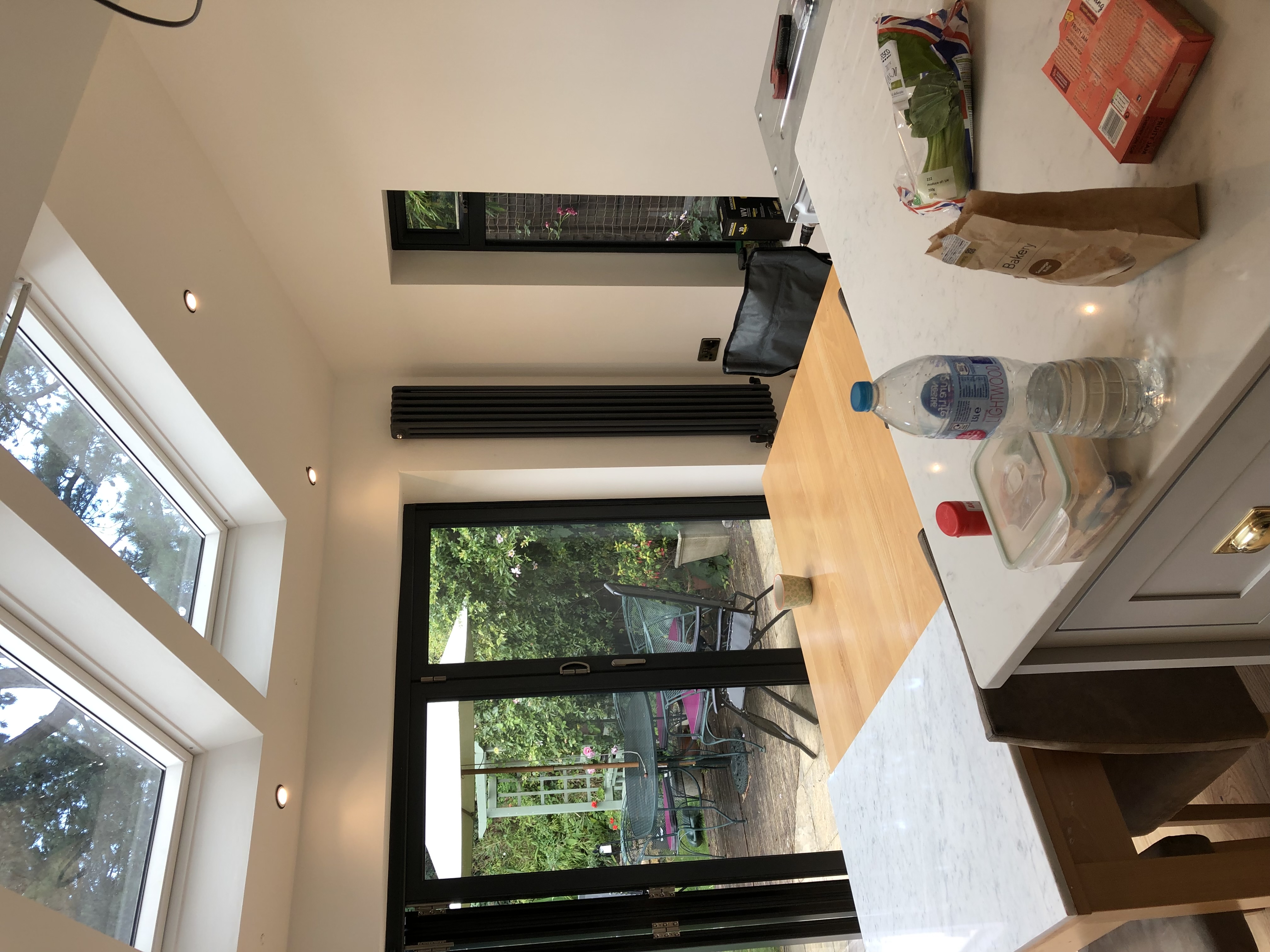 Tall contemporary radiator installed in an extension